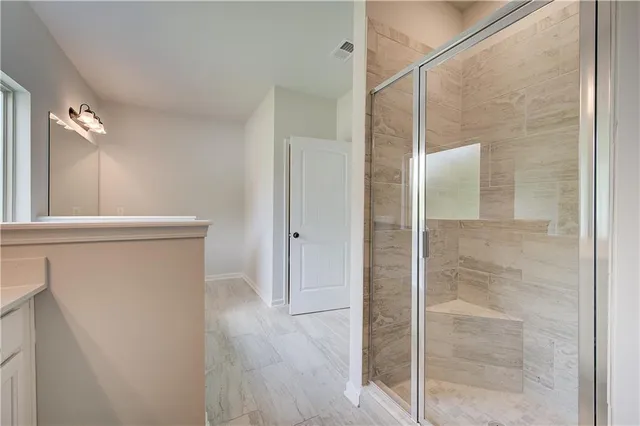 a bathroom with a shower and a sink