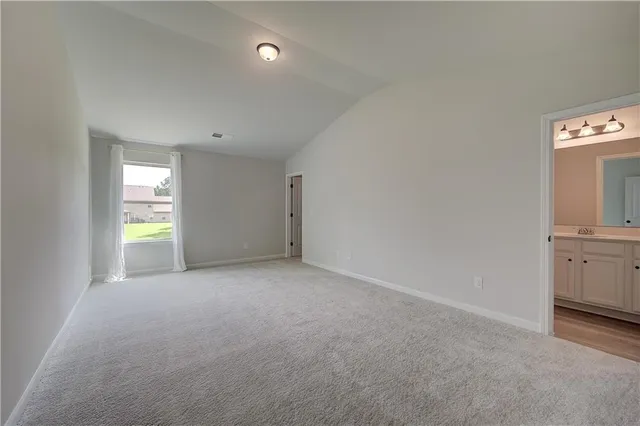 a view of a hallway with wooden floor and windows