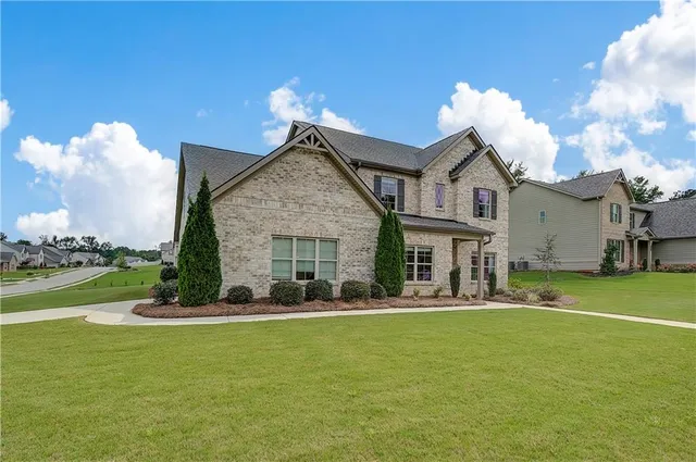 a front view of a house with garden