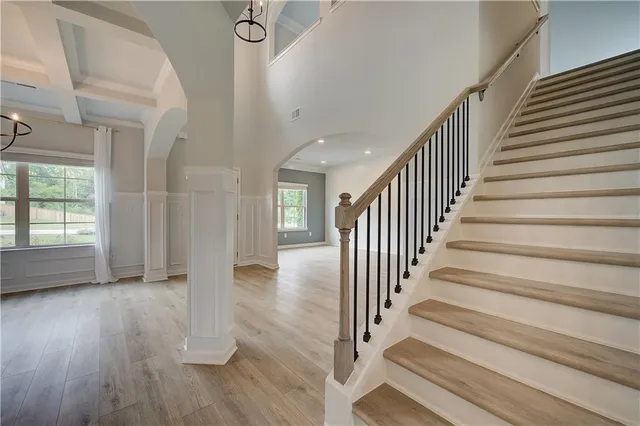 a view of staircase with wooden floor and fan