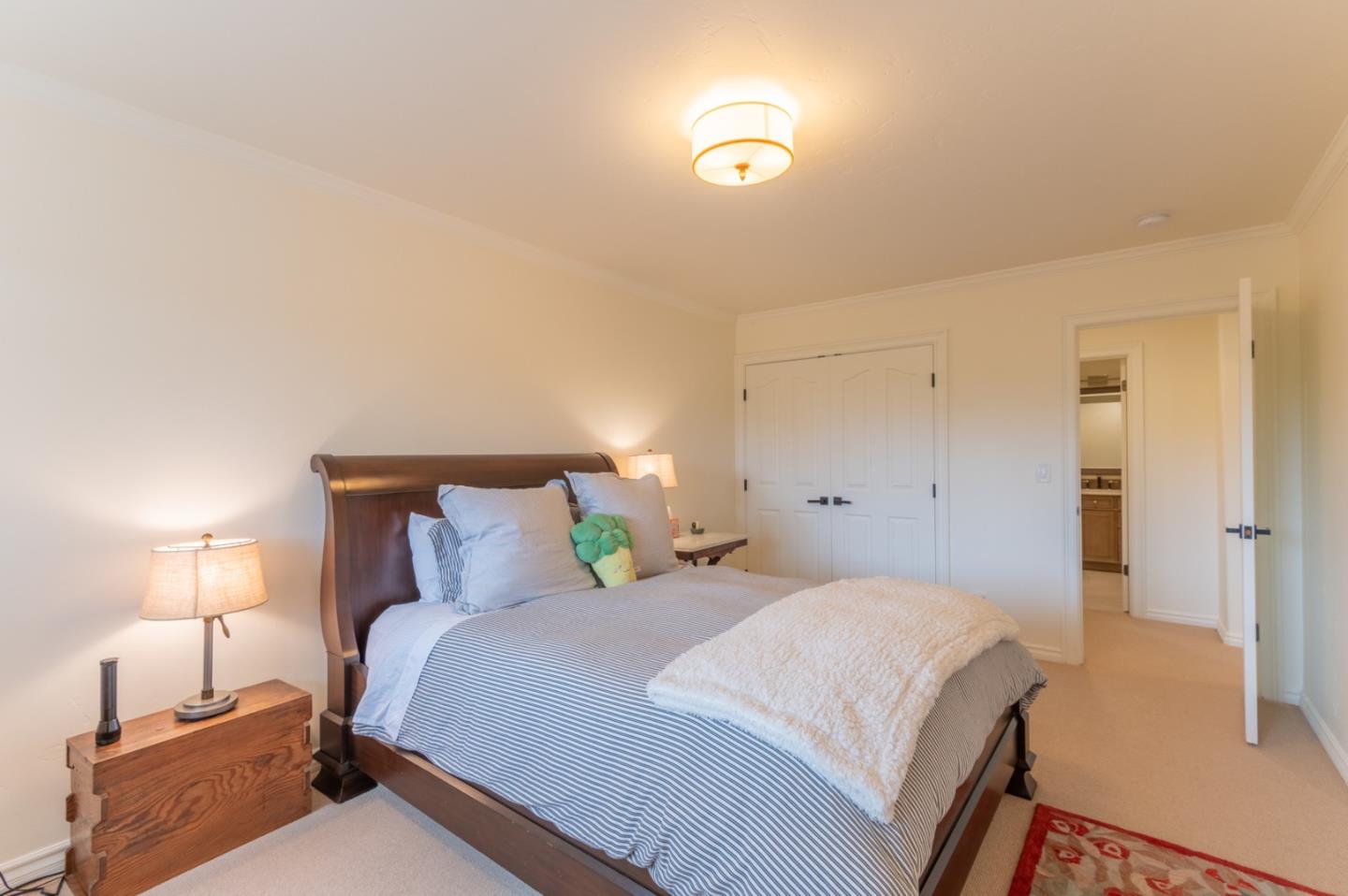 26345 Ladera Drive Carmel, CA 93923 - Photo 33 of 41 a bedroom with a bed and a lamp