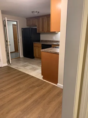 a kitchen with a refrigerator and a stove top oven
