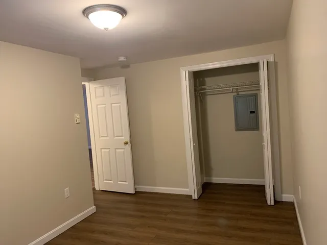 an empty room with wooden floor and closet