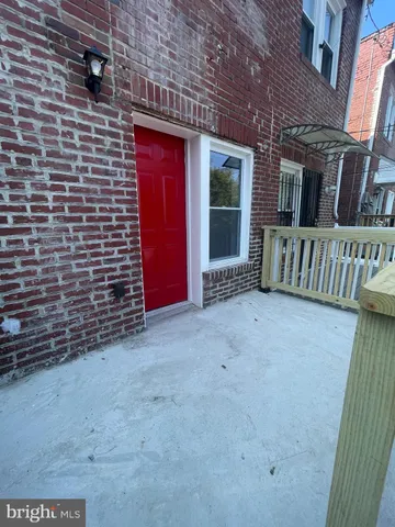 a view of an empty room with brick walls