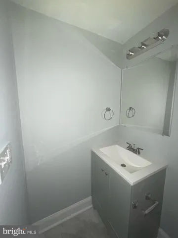 a bathroom with a sink a mirror and vanity