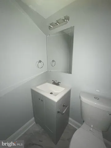 a bathroom with a sink toilet and mirror