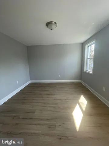 a view of room window and wooden floor