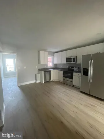 a kitchen with stainless steel appliances a refrigerator and a microwave