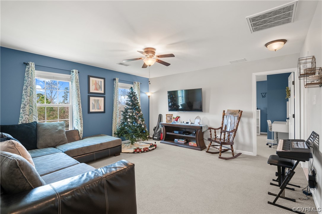 7031 Crackerberry Drive Moseley, VA 23120 - Photo 26 of 47 a living room with furniture and a flat screen tv with wooden floor