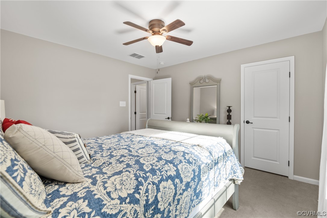 7031 Crackerberry Drive Moseley, VA 23120 - Photo 28 of 47 a bedroom with a bed and a chandelier