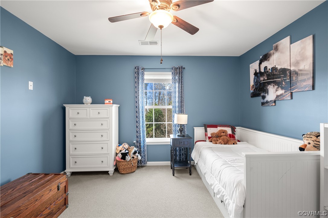 7031 Crackerberry Drive Moseley, VA 23120 - Photo 31 of 47 a bedroom with a bed and a chandelier