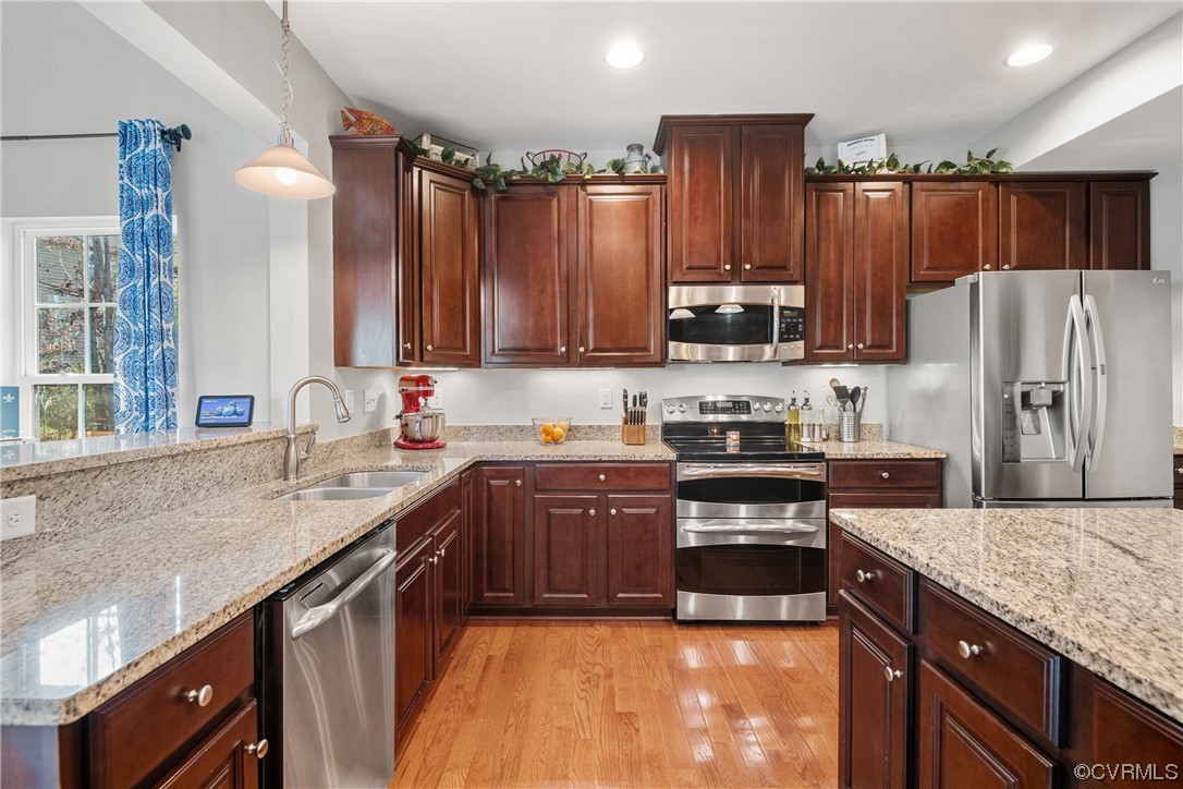 7031 Crackerberry Drive Moseley, VA 23120 - Photo 5 of 47 a kitchen with granite countertop a sink stove and refrigerator