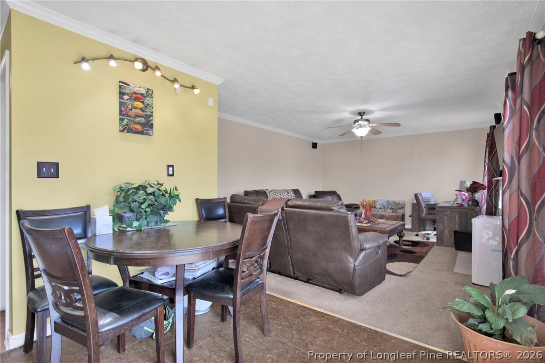 429 Bristlecone Road Fayetteville, NC 28311 - Photo 13 of 38 a view of a dining room with furniture and a chandelier