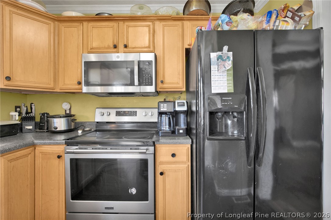 429 Bristlecone Road Fayetteville, NC 28311 - Photo 16 of 38 a kitchen with stainless steel appliances granite countertop a stove a washer and dryer