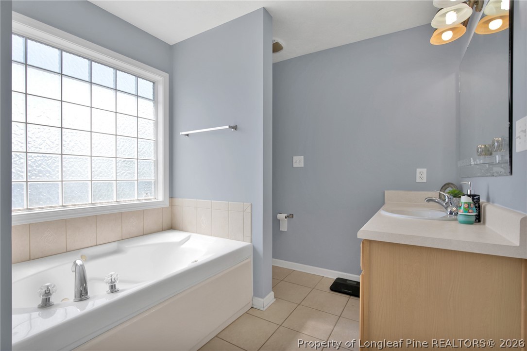 429 Bristlecone Road Fayetteville, NC 28311 - Photo 21 of 38 a bathroom with a tub sink and mirror