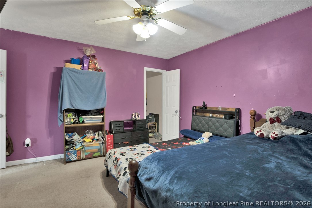 429 Bristlecone Road Fayetteville, NC 28311 - Photo 24 of 38 a bed room with a bed and a chandelier