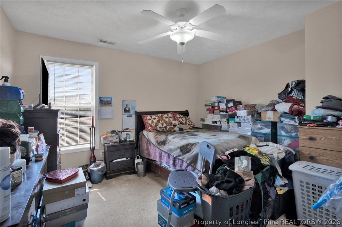 429 Bristlecone Road Fayetteville, NC 28311 - Photo 25 of 38 a bed room with a bed and a chandelier