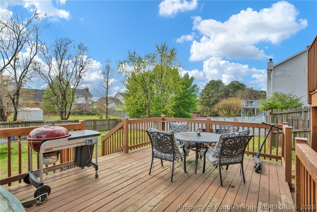 429 Bristlecone Road Fayetteville, NC 28311 - Photo 32 of 38 a view of a patio with table and chairs with wooden floor and fence