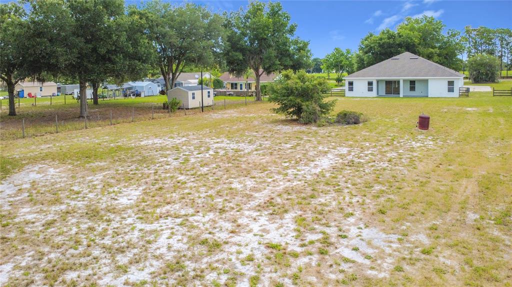 28549 Shirley Shores Road Tavares, FL 32778 - Photo 60 of 65 a view of a house with a yard and a large tree