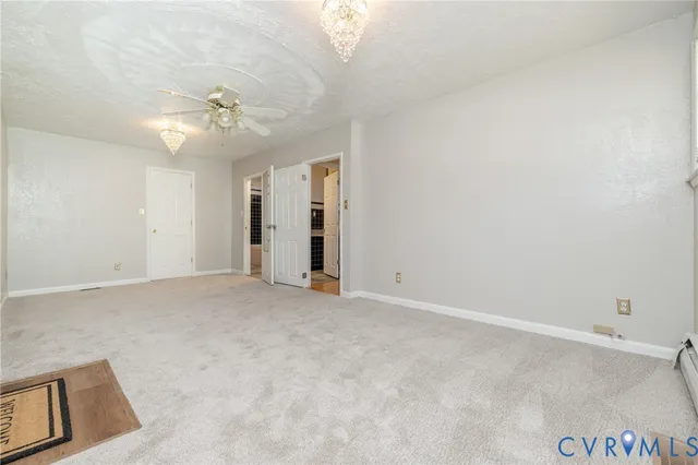an empty room with closet and a ceiling fan
