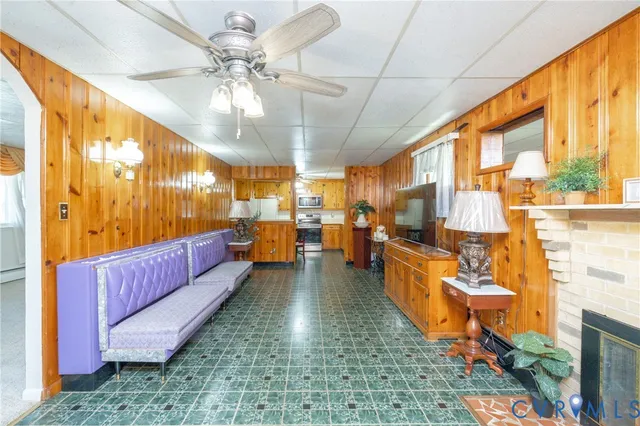 a kitchen with stainless steel appliances granite countertop a refrigerator a stove and a sink with wooden floor