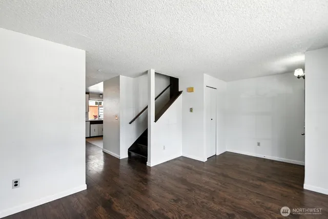 a view of a room with wooden floor and stairs