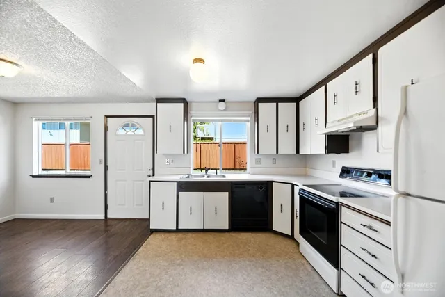 a kitchen with stainless steel appliances granite countertop a stove sink and cabinets