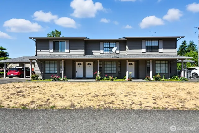 a front view of a building with a yard