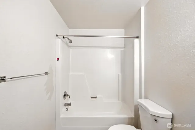 a bathroom with a shower and a toilet