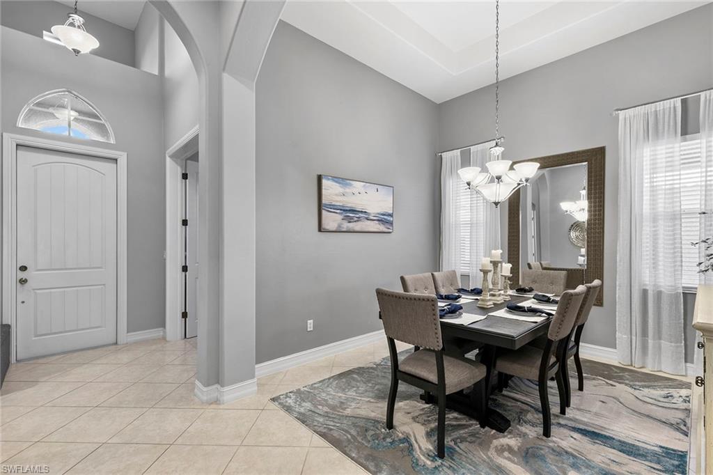 7778 Ashton Road Naples, FL 34113 - Photo 11 of 26 a view of a dining room with furniture and window