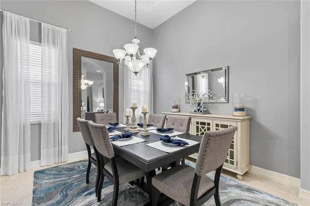 a view of a a dining room with furniture window and wooden floor