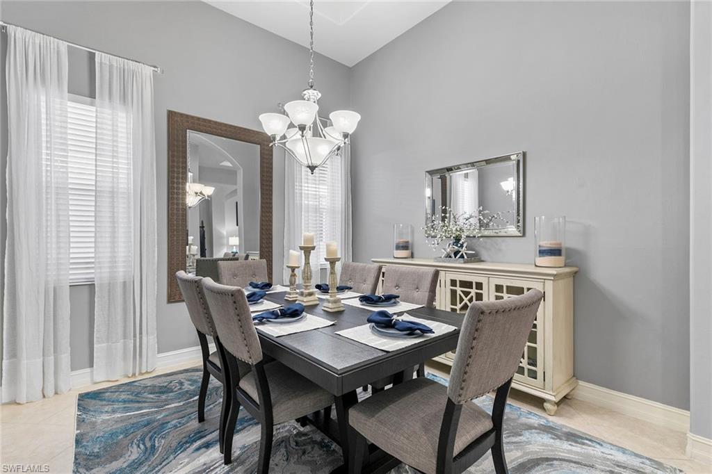7778 Ashton Road Naples, FL 34113 - Photo 12 of 26 a view of a a dining room with furniture window and wooden floor