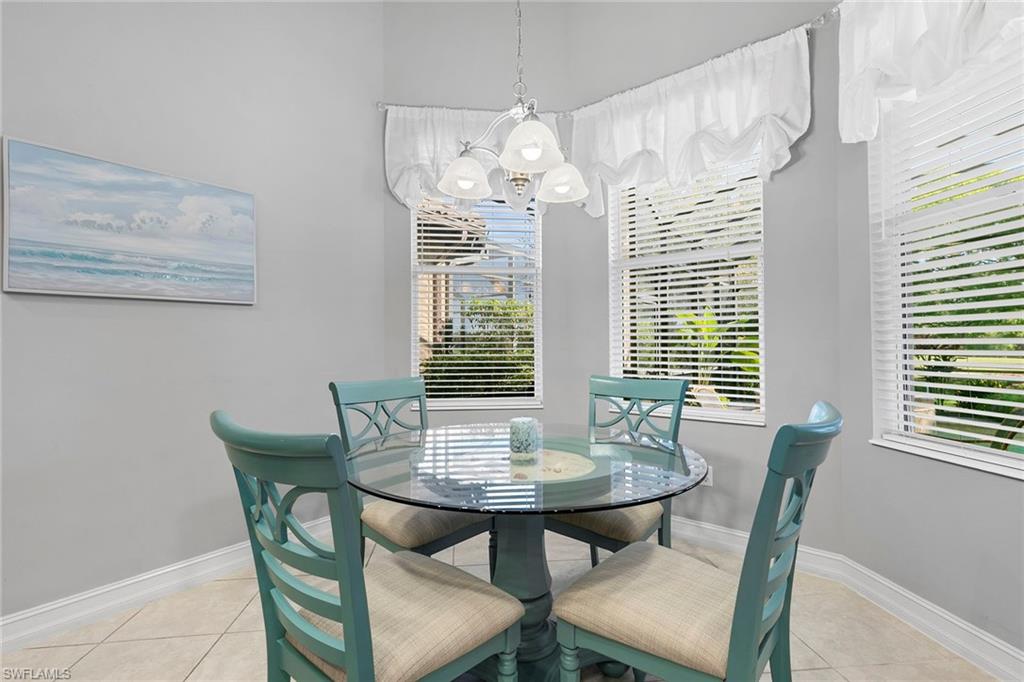 7778 Ashton Road Naples, FL 34113 - Photo 13 of 26 a view of a dining room with furniture and window