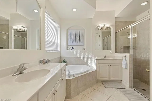 a bathroom with a sink a toilet a mirror and shower