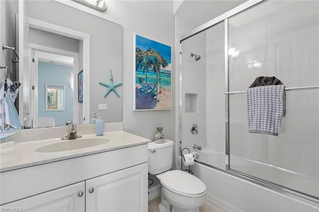a bathroom with a sink toilet vanity and shower