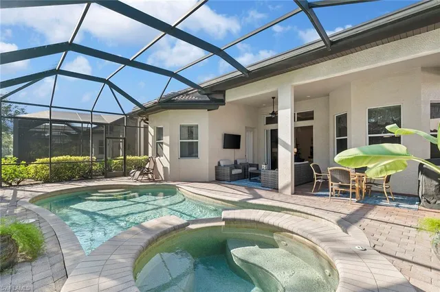 a swimming pool with outdoor seating and yard