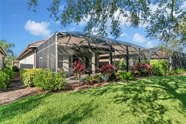 a view of a house with a big yard and potted plants