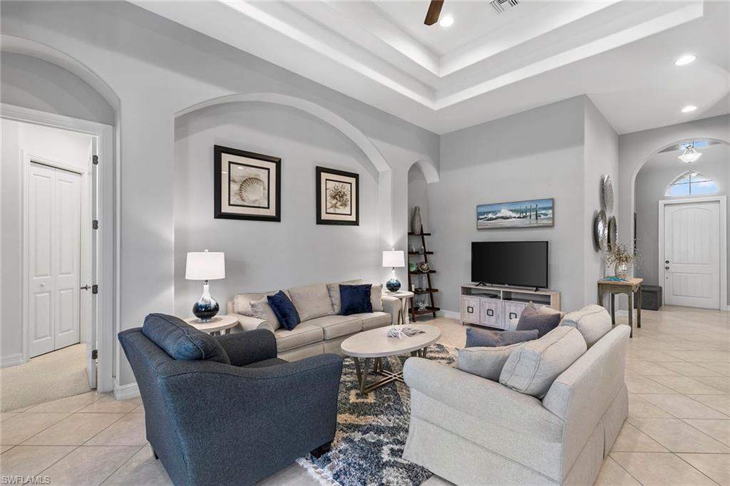 7778 Ashton Road Naples, FL 34113 - Photo 4 of 26 a living room with furniture and a flat screen tv