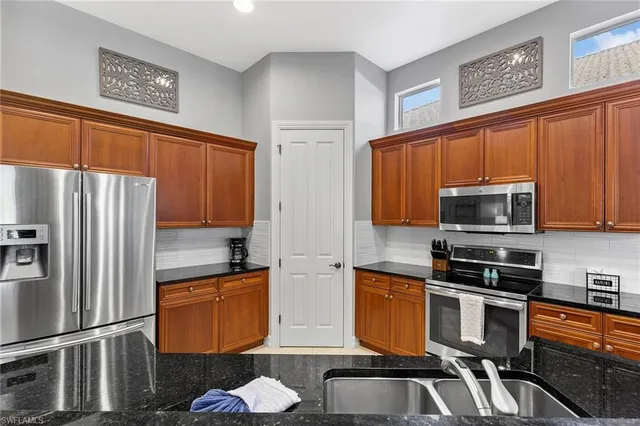 a kitchen with stainless steel appliances a stove a sink and a refrigerator