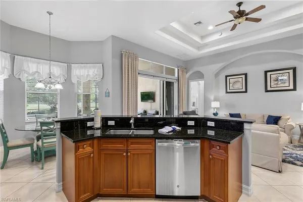 a kitchen with a counter space a sink a window and stainless steel appliances