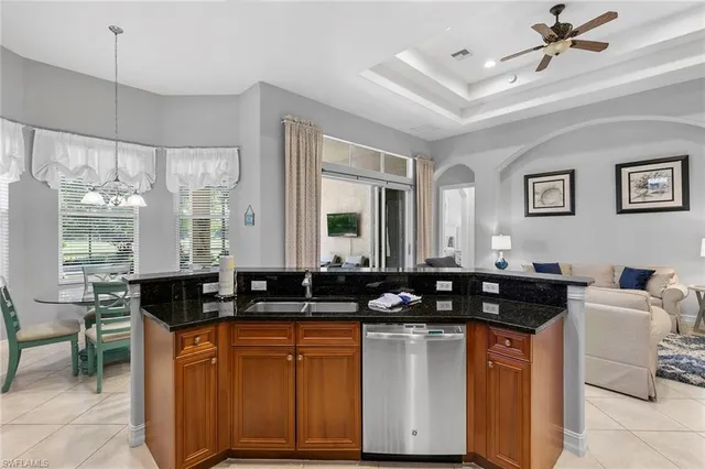 a kitchen with a counter space a sink a window and stainless steel appliances