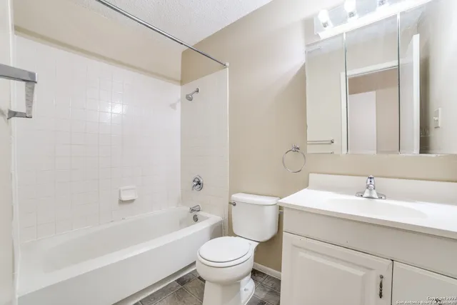a bathroom with a sink toilet mirror and bathtub
