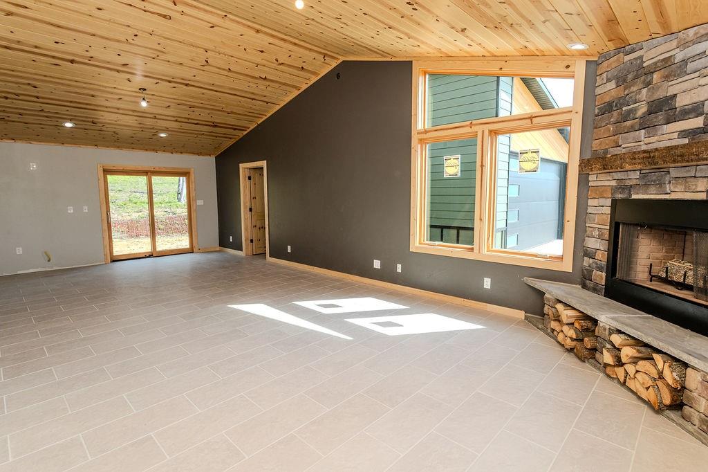 391 Sarvest Road Addison, PA 15411 - Photo 13 of 33 a view of an empty room with a fireplace and a window