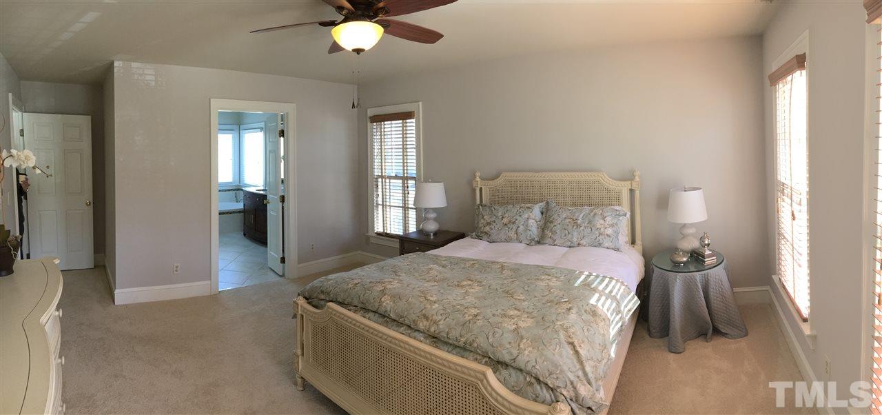 2506 Mayview Road Raleigh, NC 27607 - Photo 11 of 29 a spacious bedroom with a bed and ceiling fan