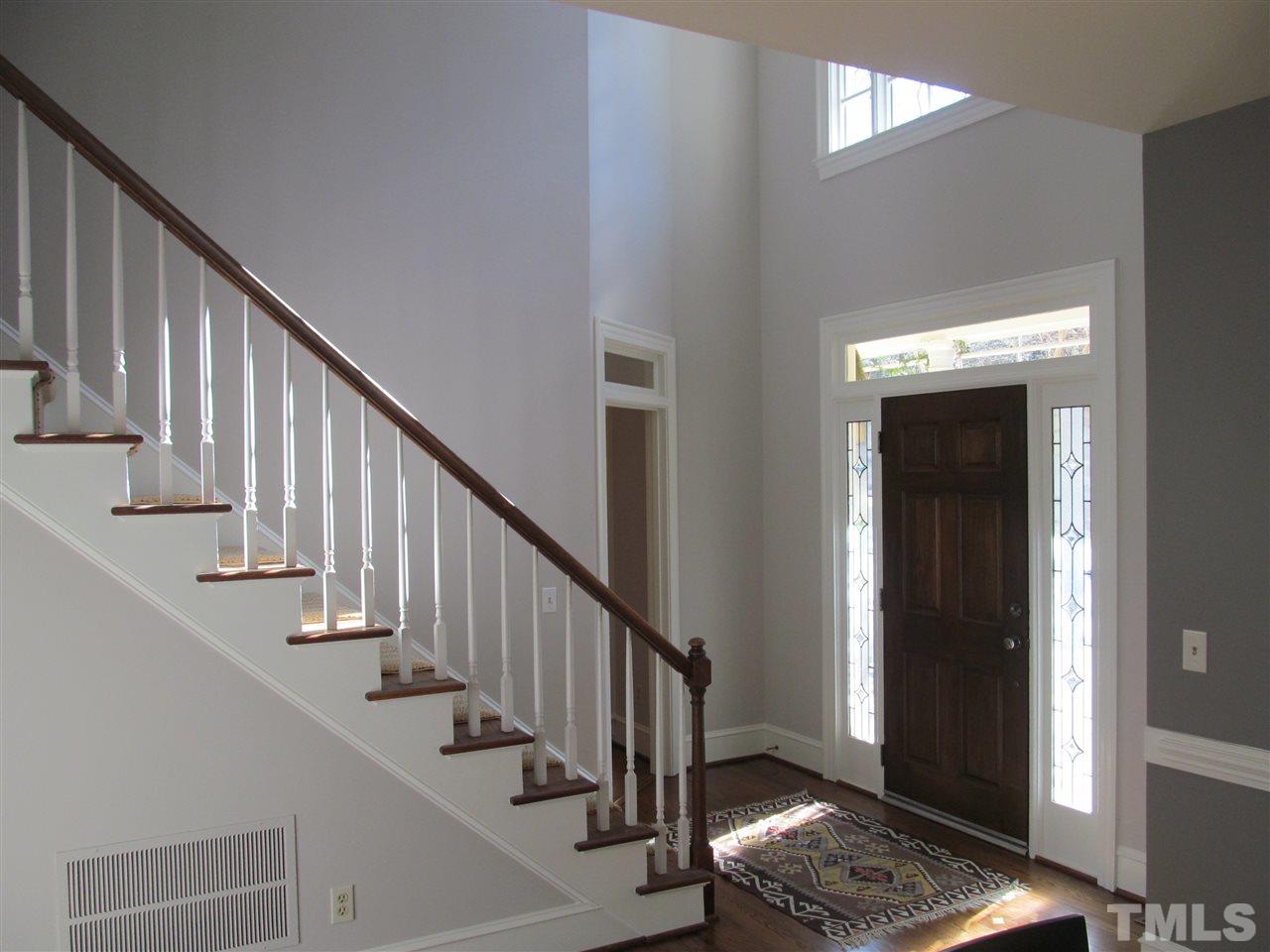 2506 Mayview Road Raleigh, NC 27607 - Photo 4 of 29 a view of entryway with wooden floor and stairs