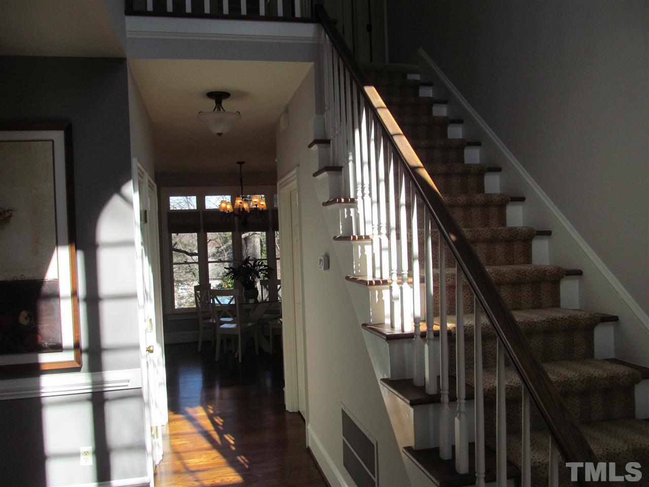 2506 Mayview Road Raleigh, NC 27607 - Photo 5 of 29 a view of staircase with lots of frames on wall and windows