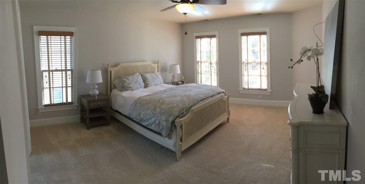 2506 Mayview Road Raleigh, NC 27607 - Photo 10 of 29 a bedroom with a bed and a flat tv screen on the dresser