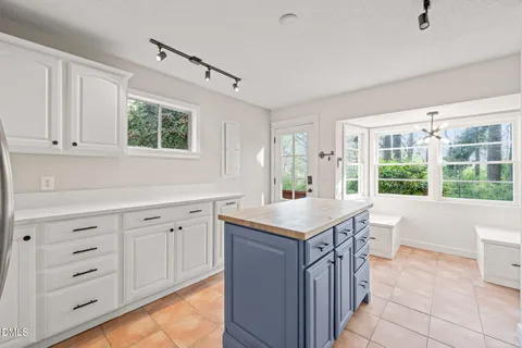 a kitchen with stainless steel appliances granite countertop a refrigerator and a stove