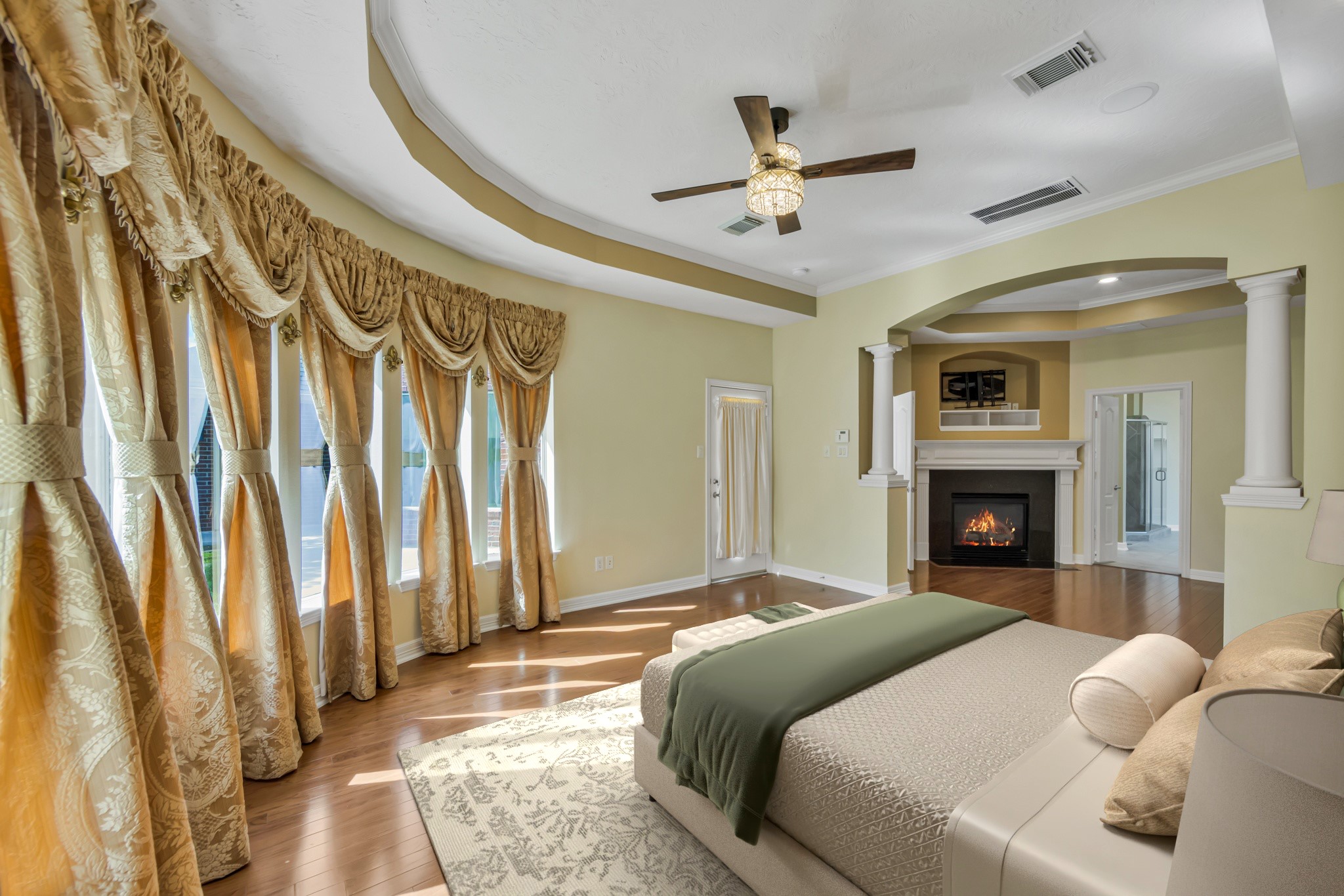 10410 Kilbride Way Court Spring, TX 77379 - Photo 18 of 49 *Virtually staged* The primary suite with hardwood floors, upscale lighting, beautiful windows providing views of the backyard, and a private exterior door.
