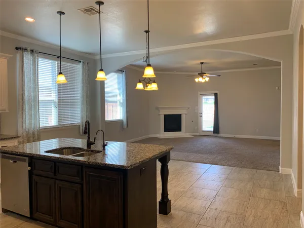 a kitchen with a sink and chandelier